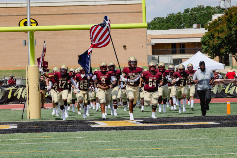 Erskine's football team runs onto the field