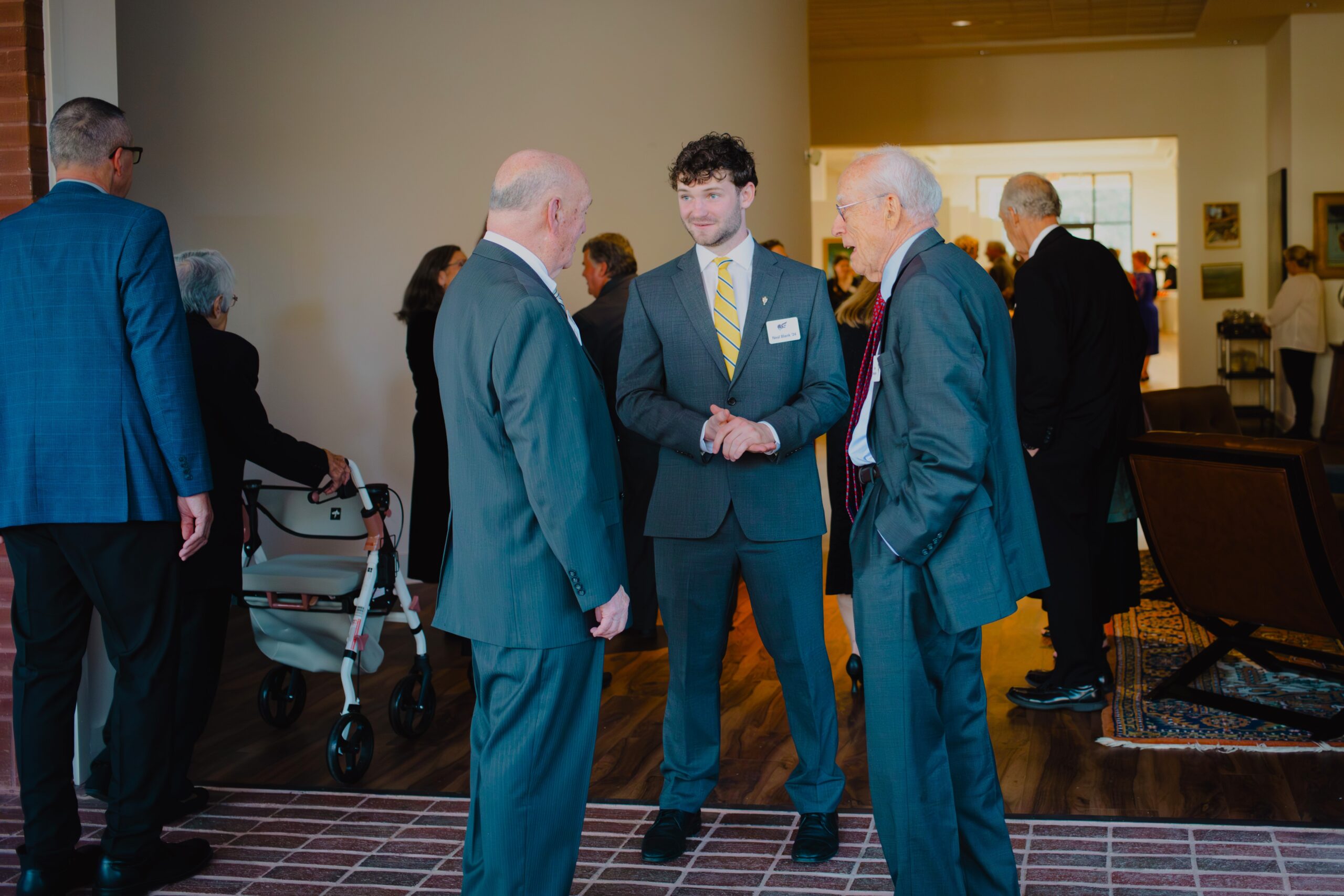 Senior Neal Blank talks with gala attendees