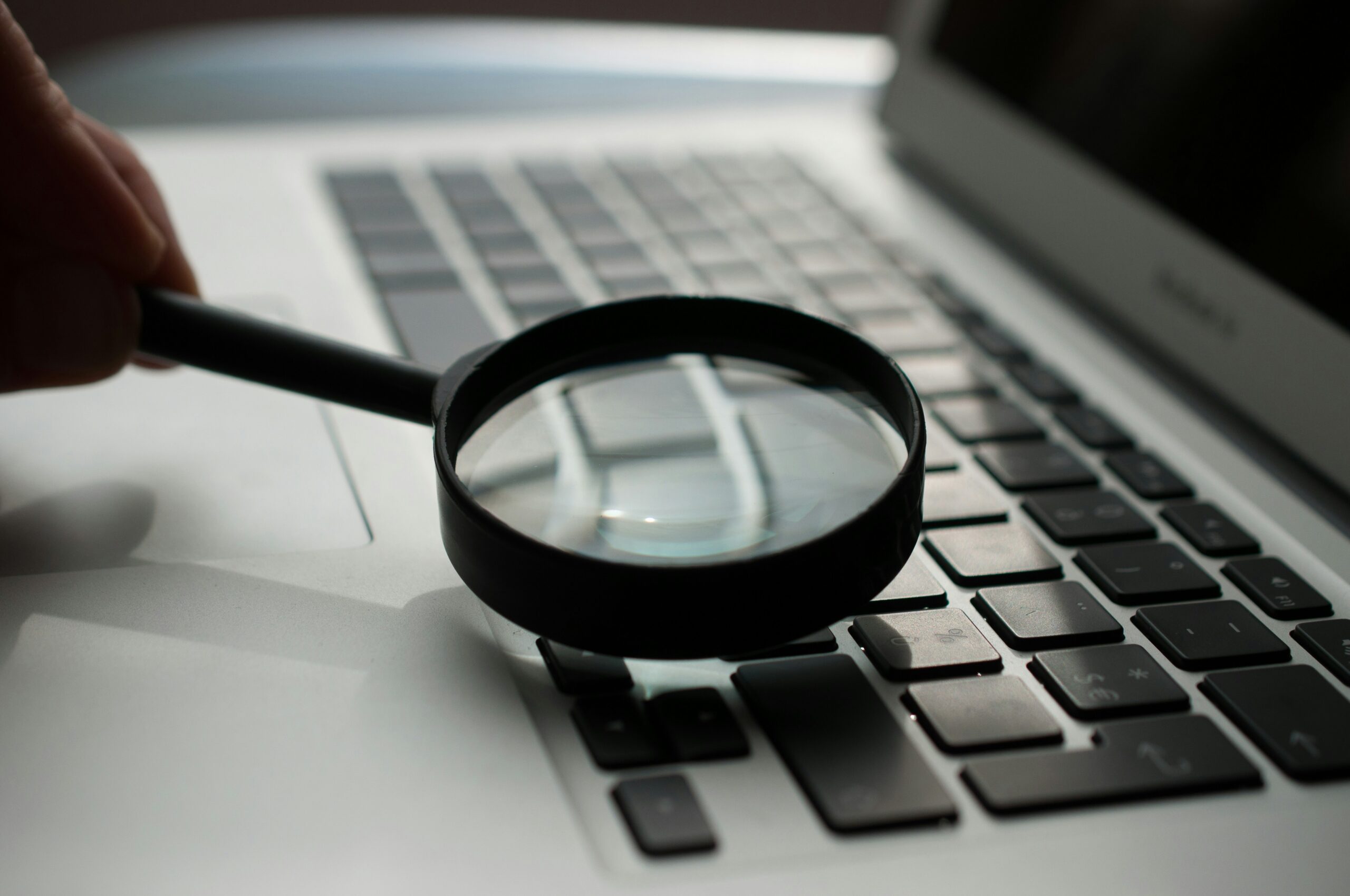 Magnifying glass with a computer.