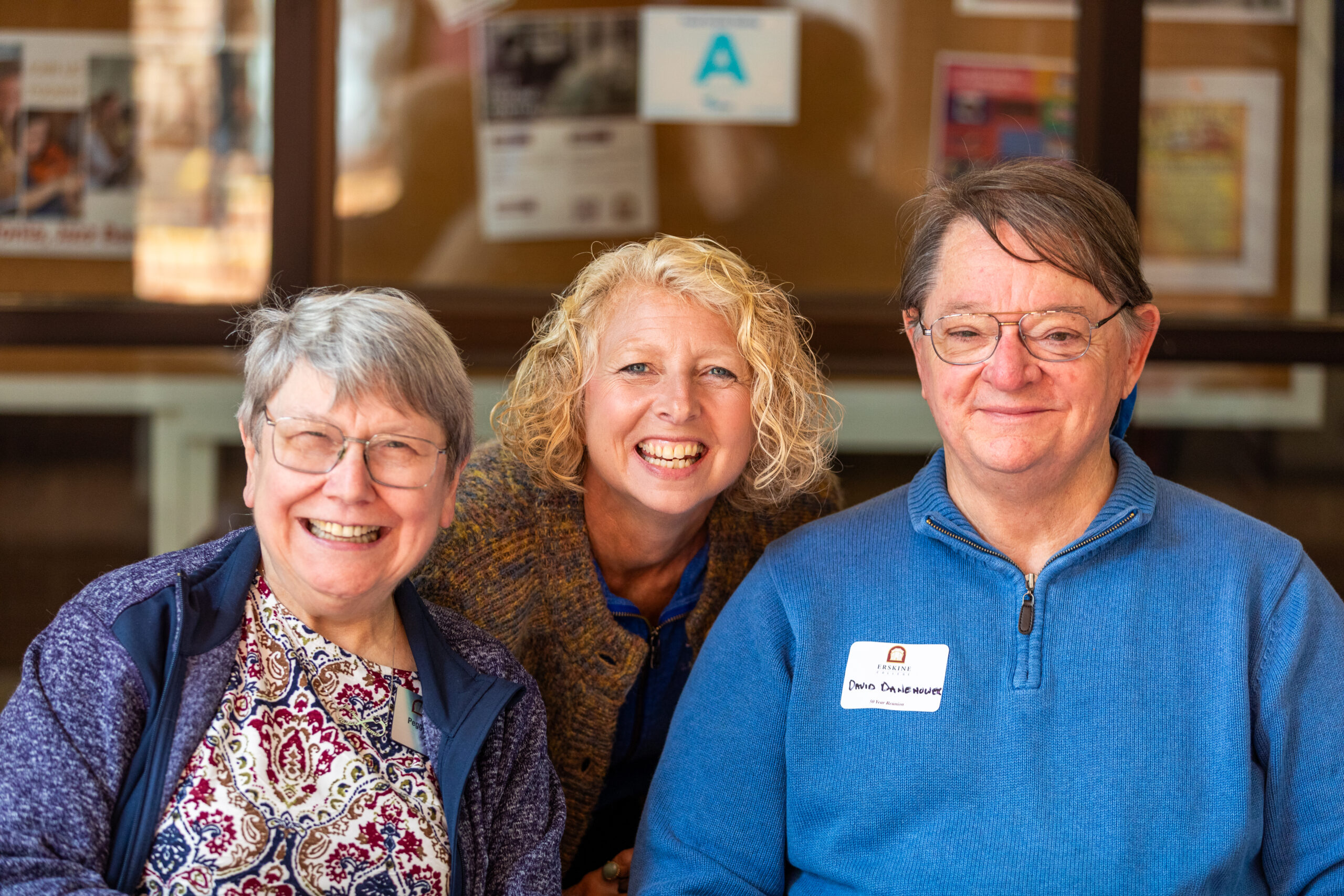 Three Erskine alumni post for a photo