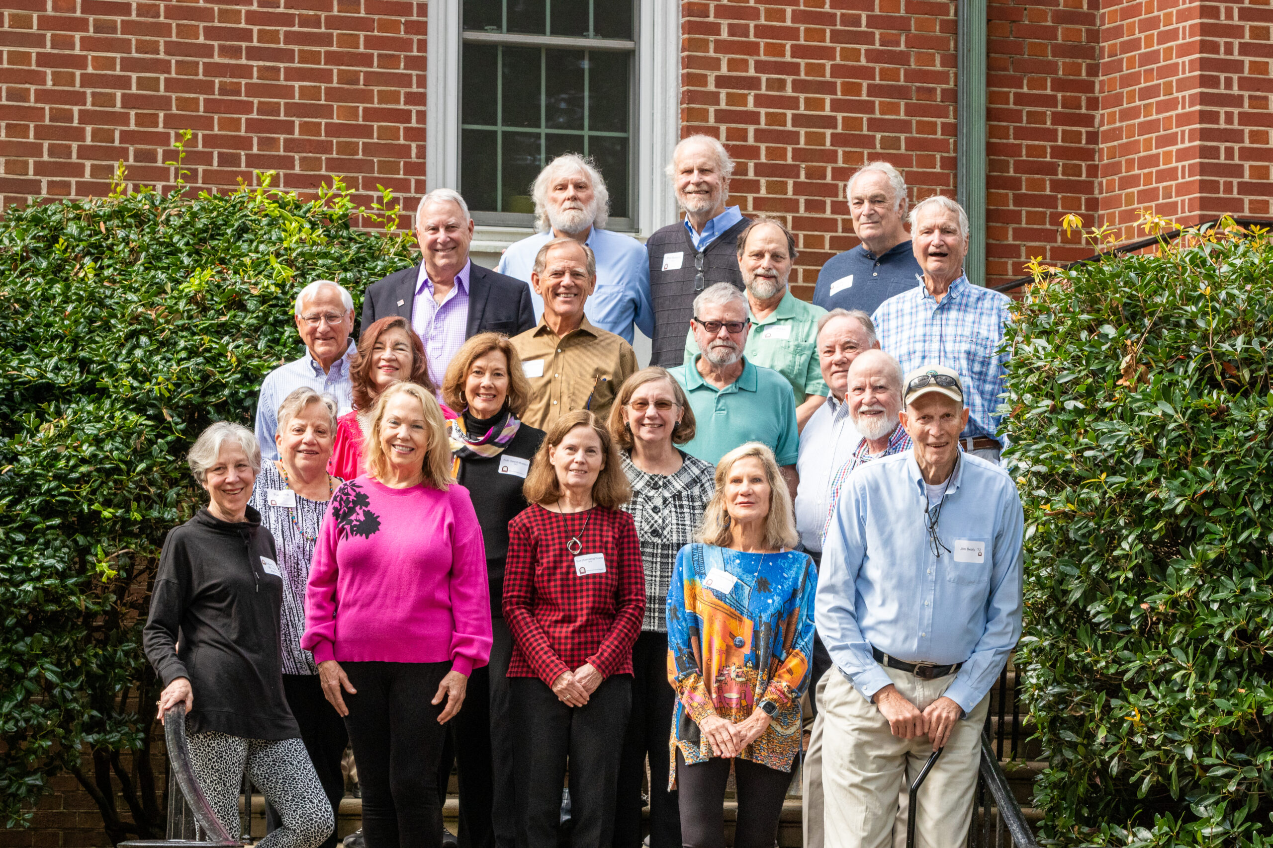 Alumni pose on the steps of Belk Hall