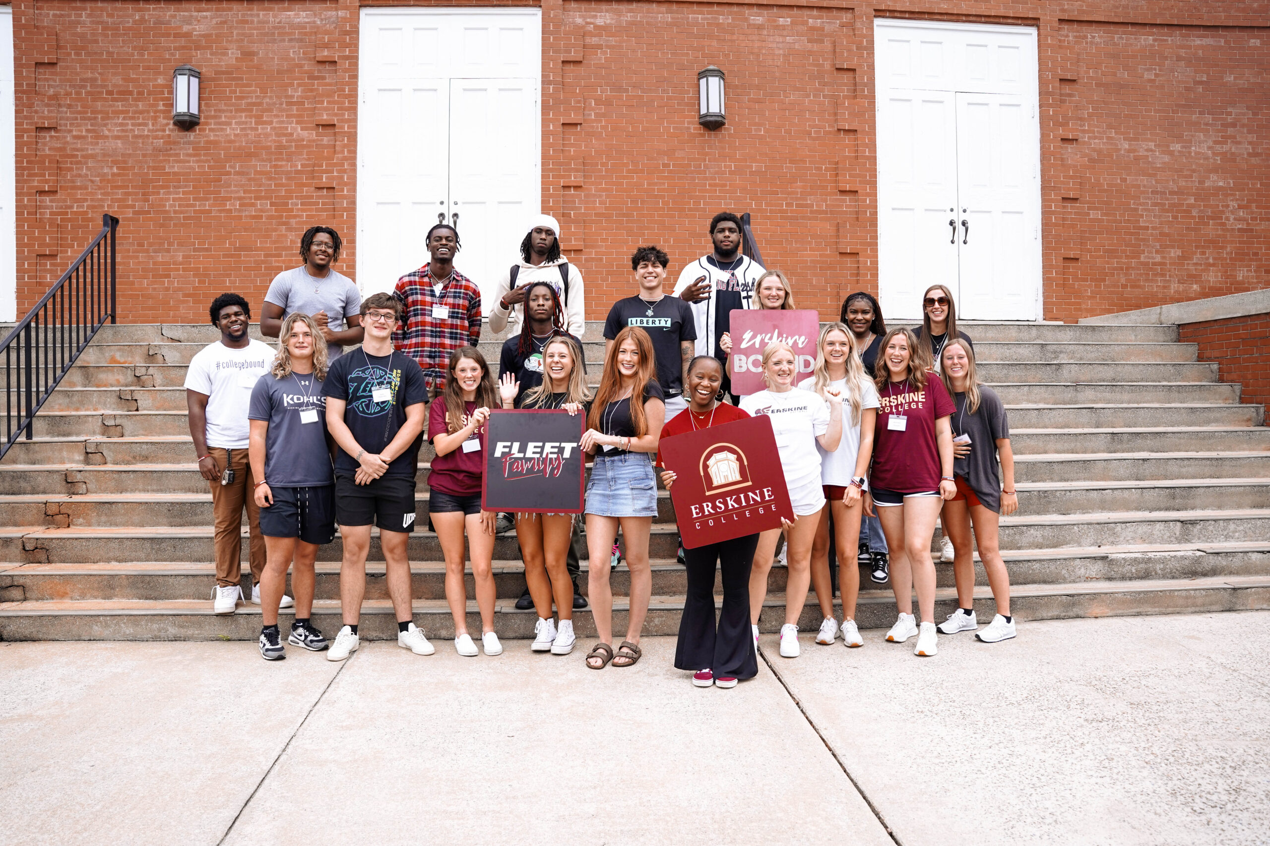 A group of new students pose on the steps of the Erskine building