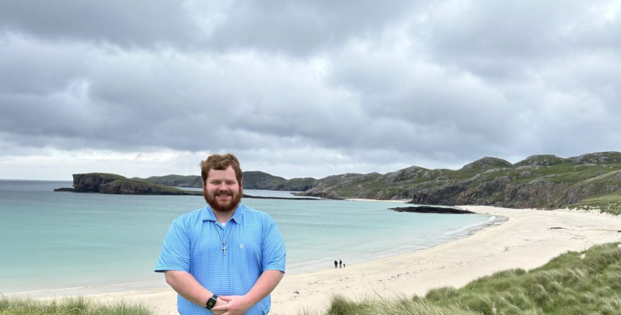 Gabriel Collier Poses At A Beach In Scotland.