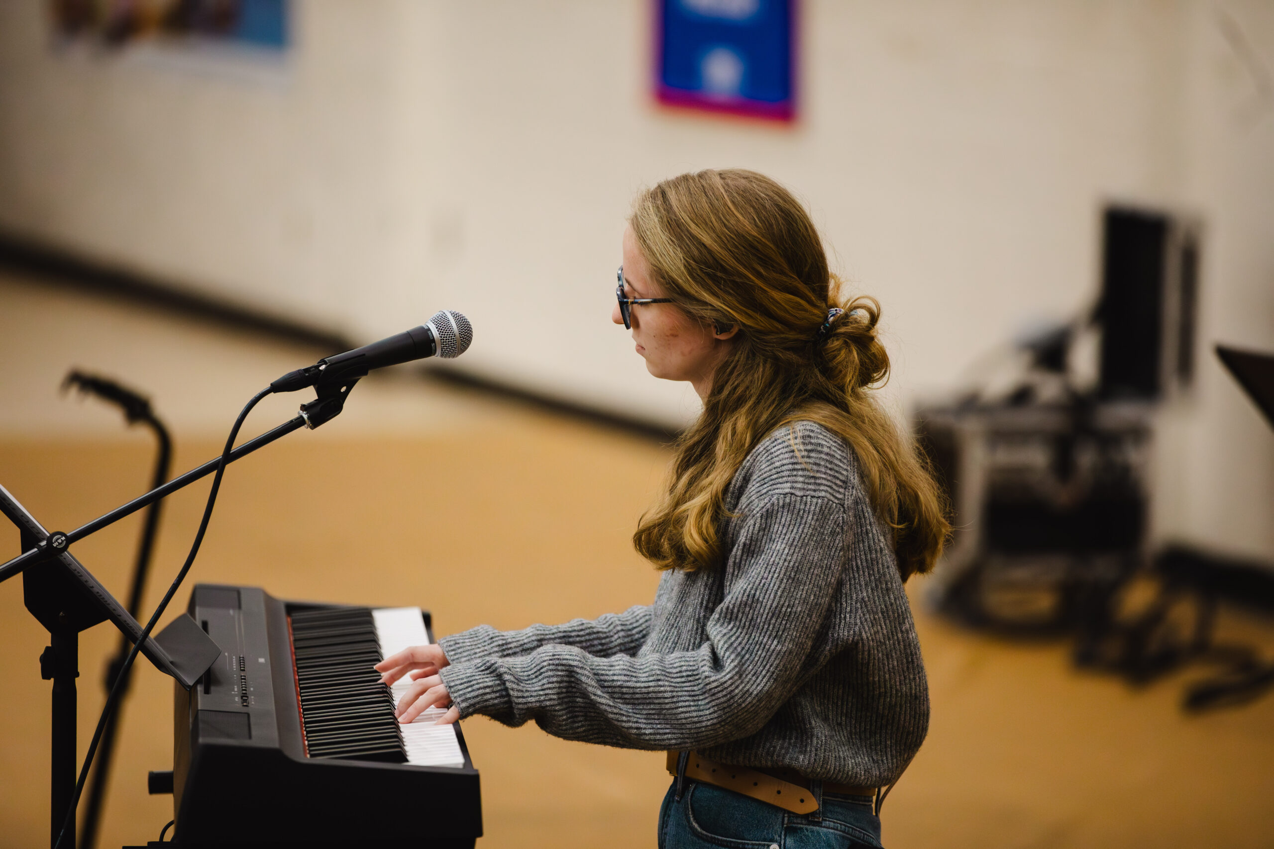 Student Ariel Bishop plays keyboard at Fleet Fellowship