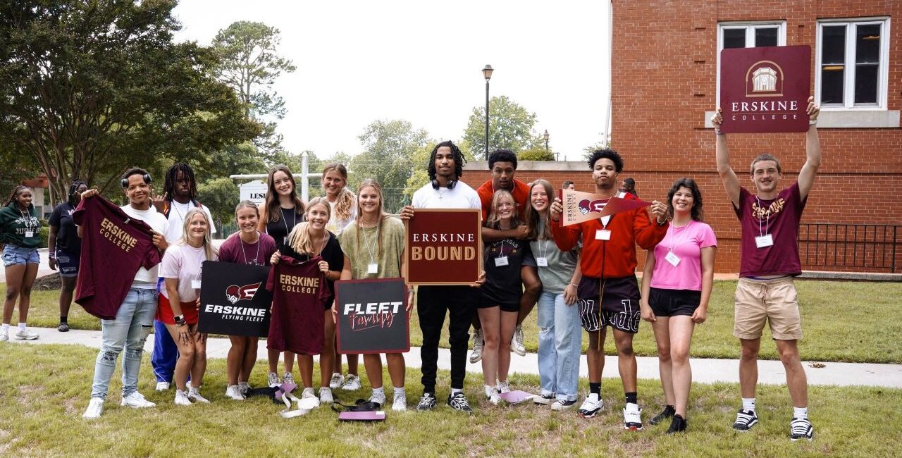 Incoming Students Pose With Erskine Signs.