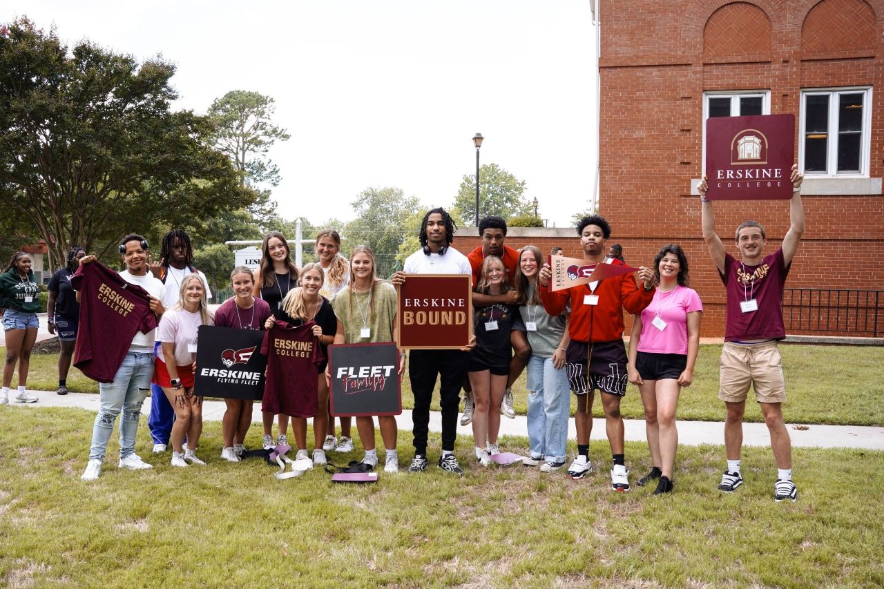 Incoming students pose with Erskine signs.