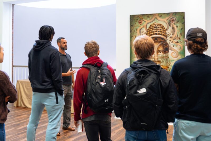 Students listen as Brian Hibbard speaks about his work.