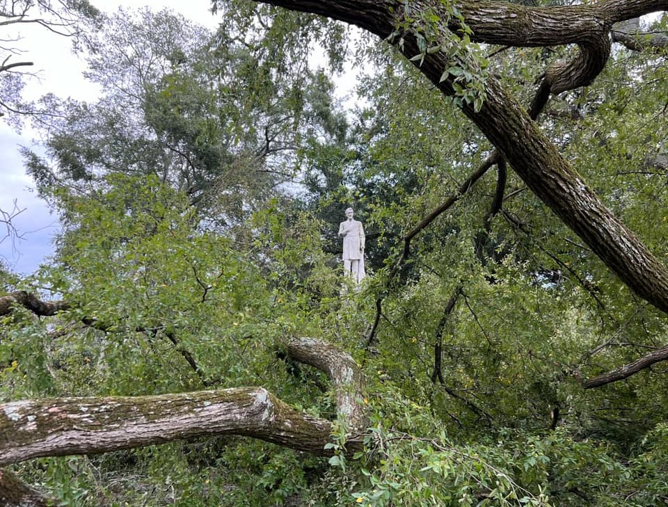 Grier statue surrounded by fallen trees