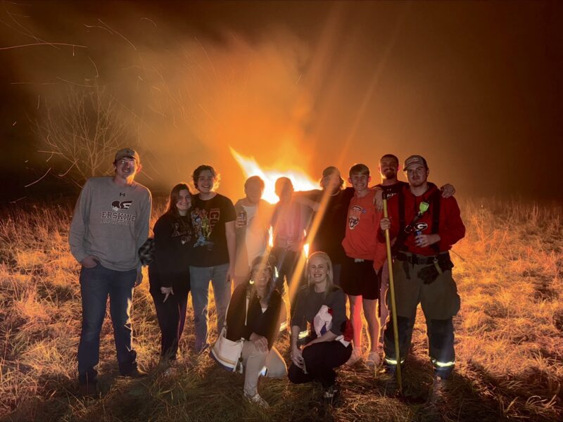 International Studies majors and guests gather behind history professors Dr. Alessandra Brivio, left, and Dr. Christiane-Marie Abu Sarah at the Guy Fawkes Day event.
