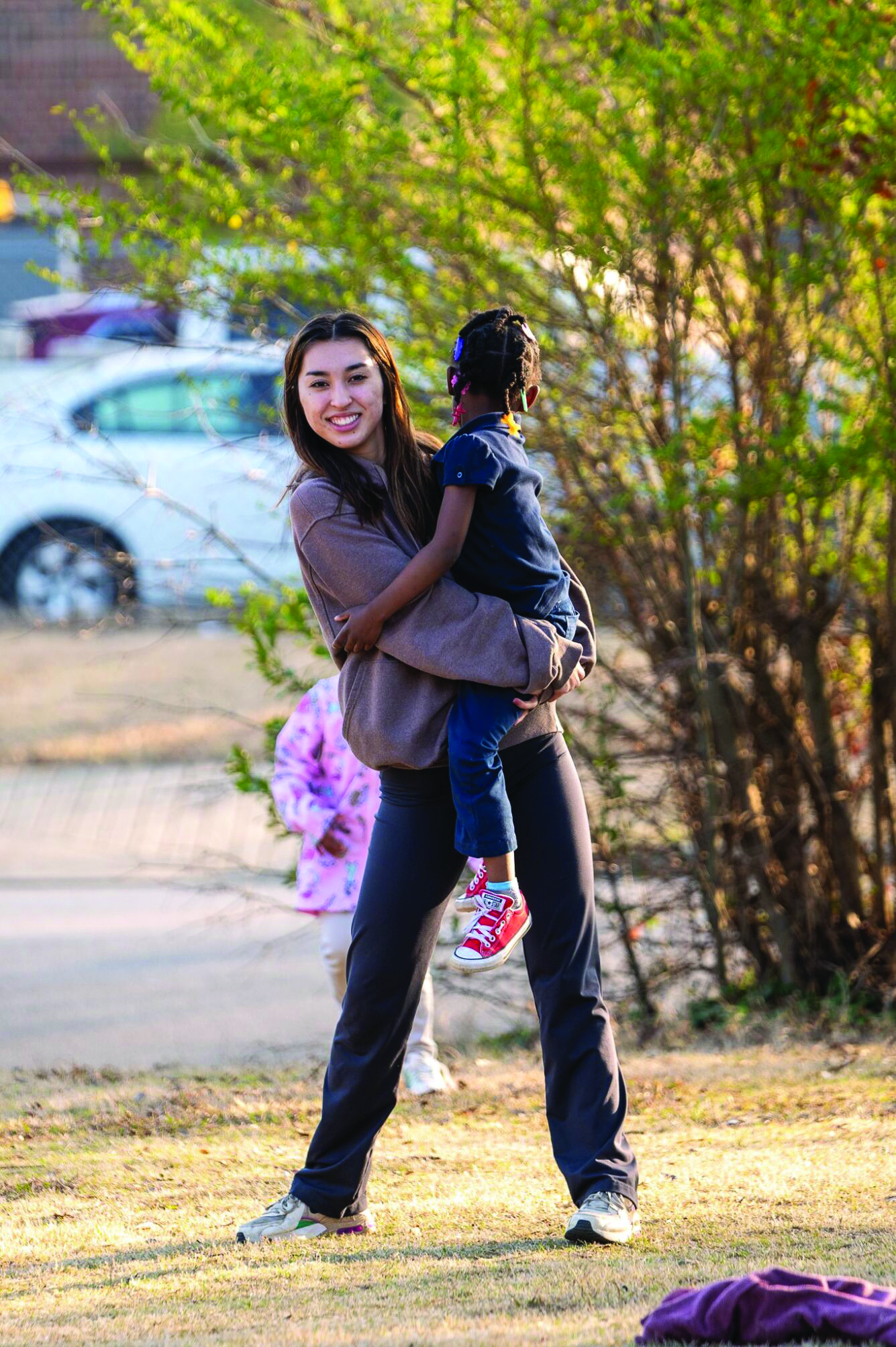 An Erskine student plays with a child on a spring break mission trip
