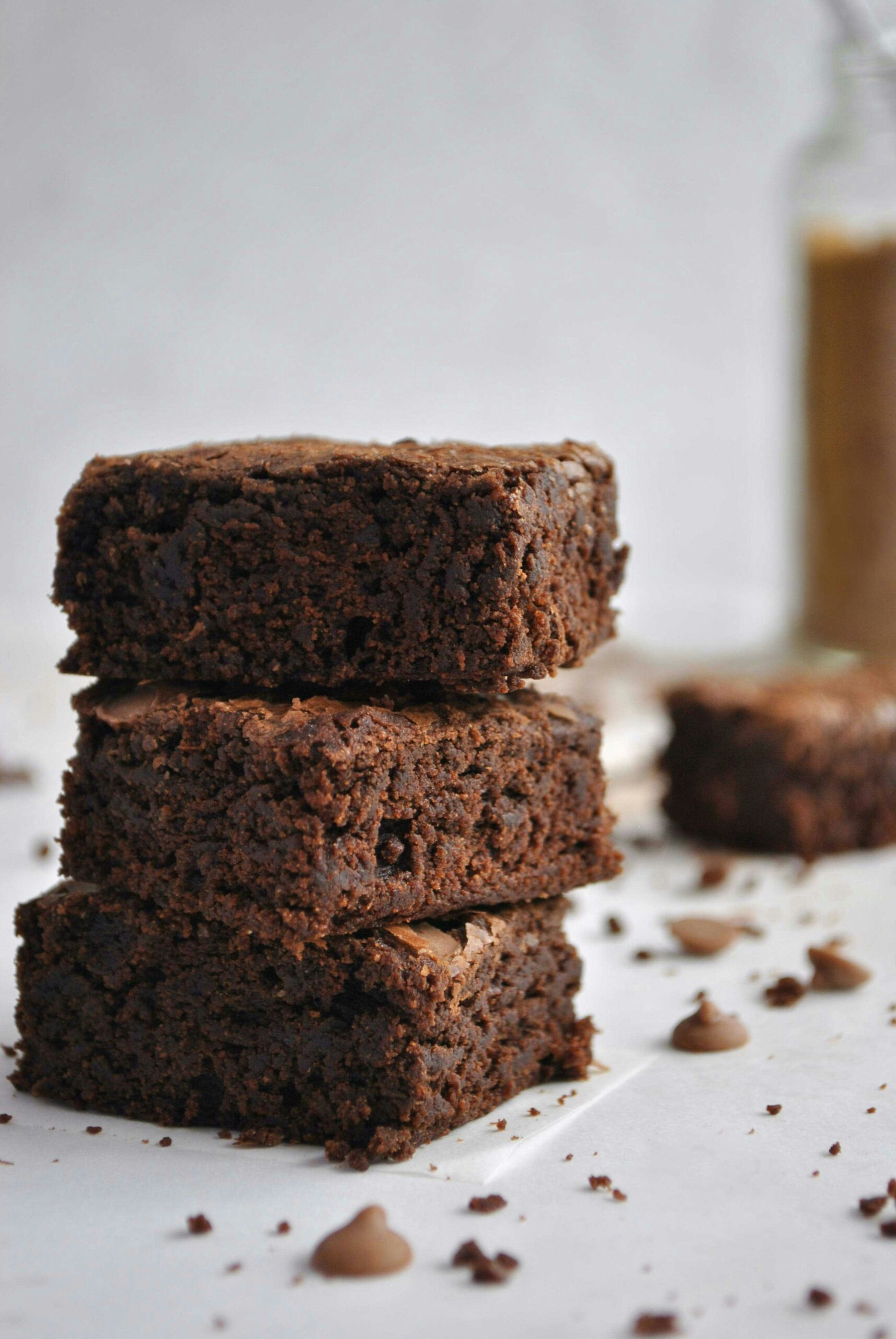 Three brownies stacked on a counter