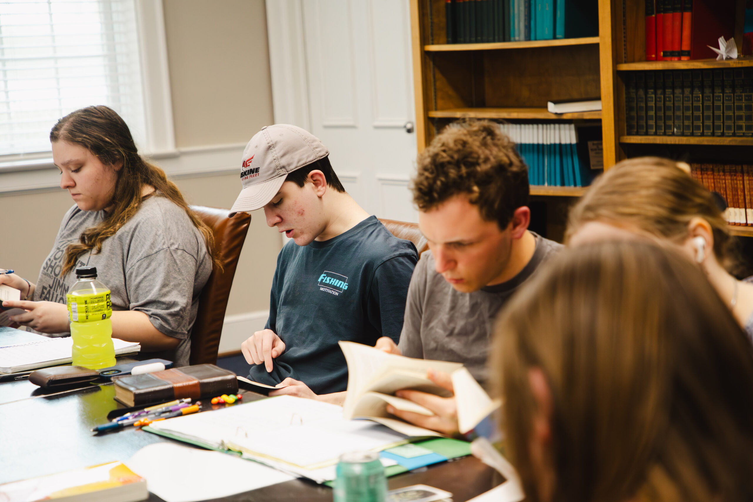 Honors students participate in a seminar around a table