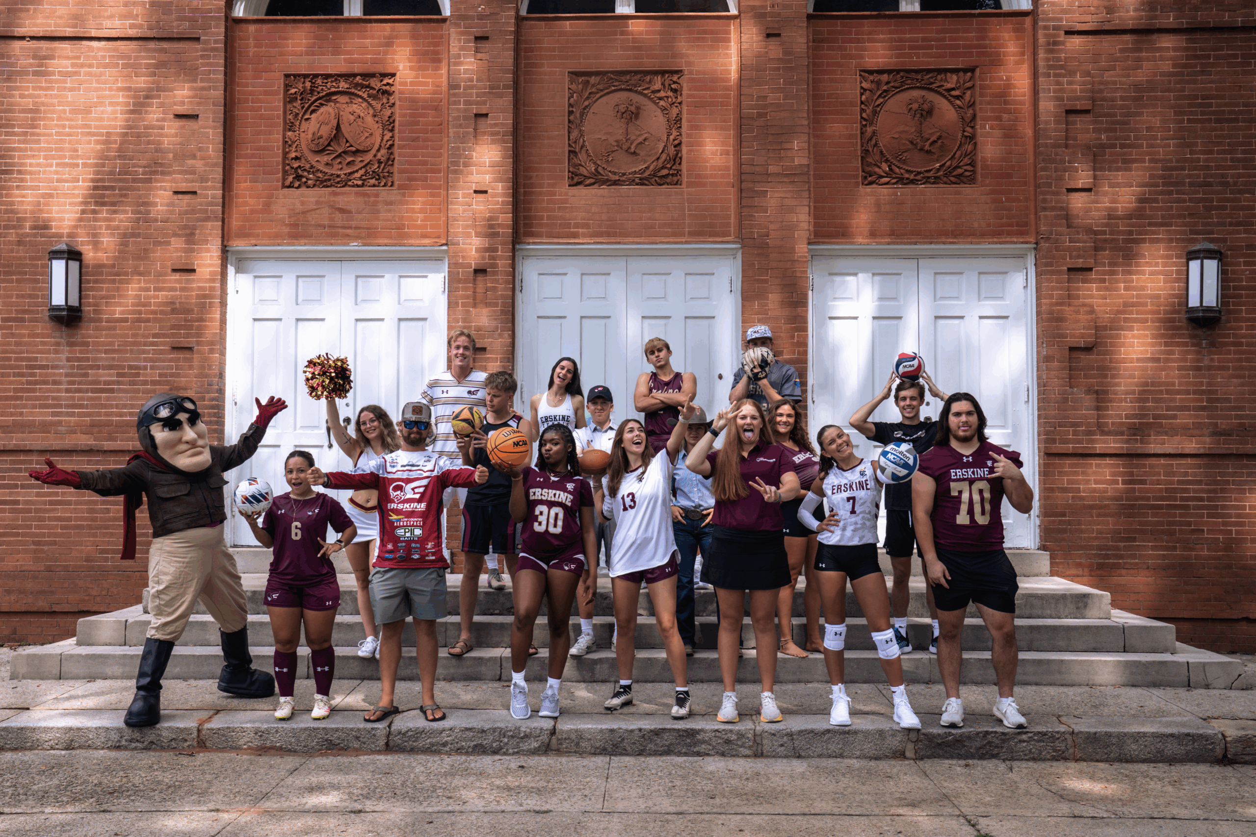 Members of Erskine Athletics pose for a fun picture in front of the Erskine Building