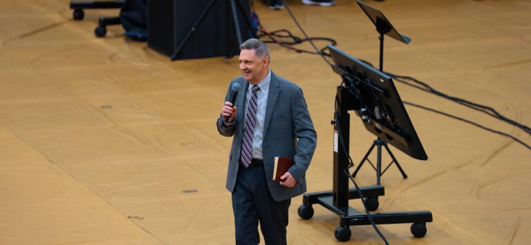 Bible in hand, Dr. Adamson addresses students at Fleet Fellowship.