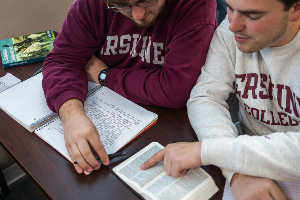 Two students study a Bible