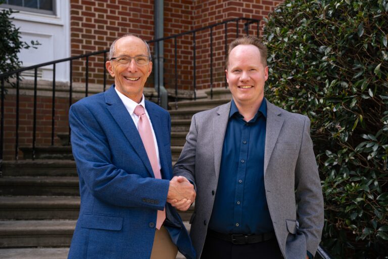 Paul Bell, left, shakes hands with Jim Sanderlin.