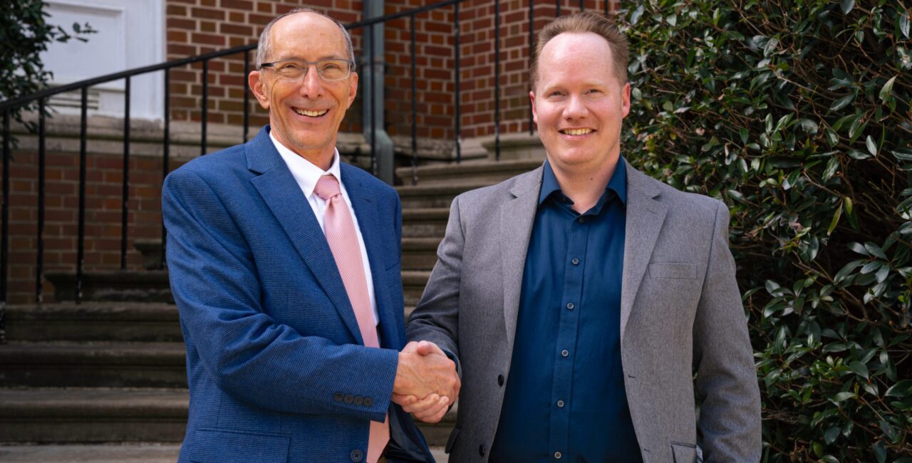 Paul Bell, left, shakes hands with Jim Sanderlin.