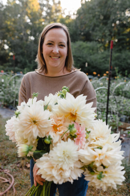 Woman holding a bouquet of dahlias