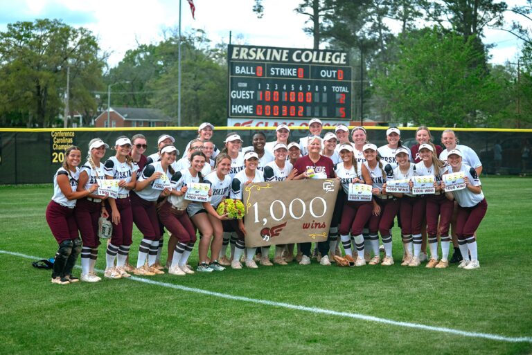 Erskine coach Alleen Hawkins poses with her team after her 1,000 win