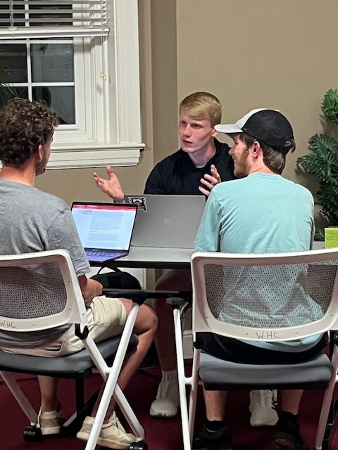 A student instructing other students at the Write Here Center