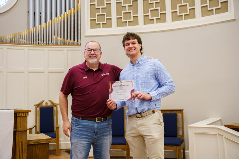 Harrison Bult receives his Stanford Award certificate from Harrison Bult.