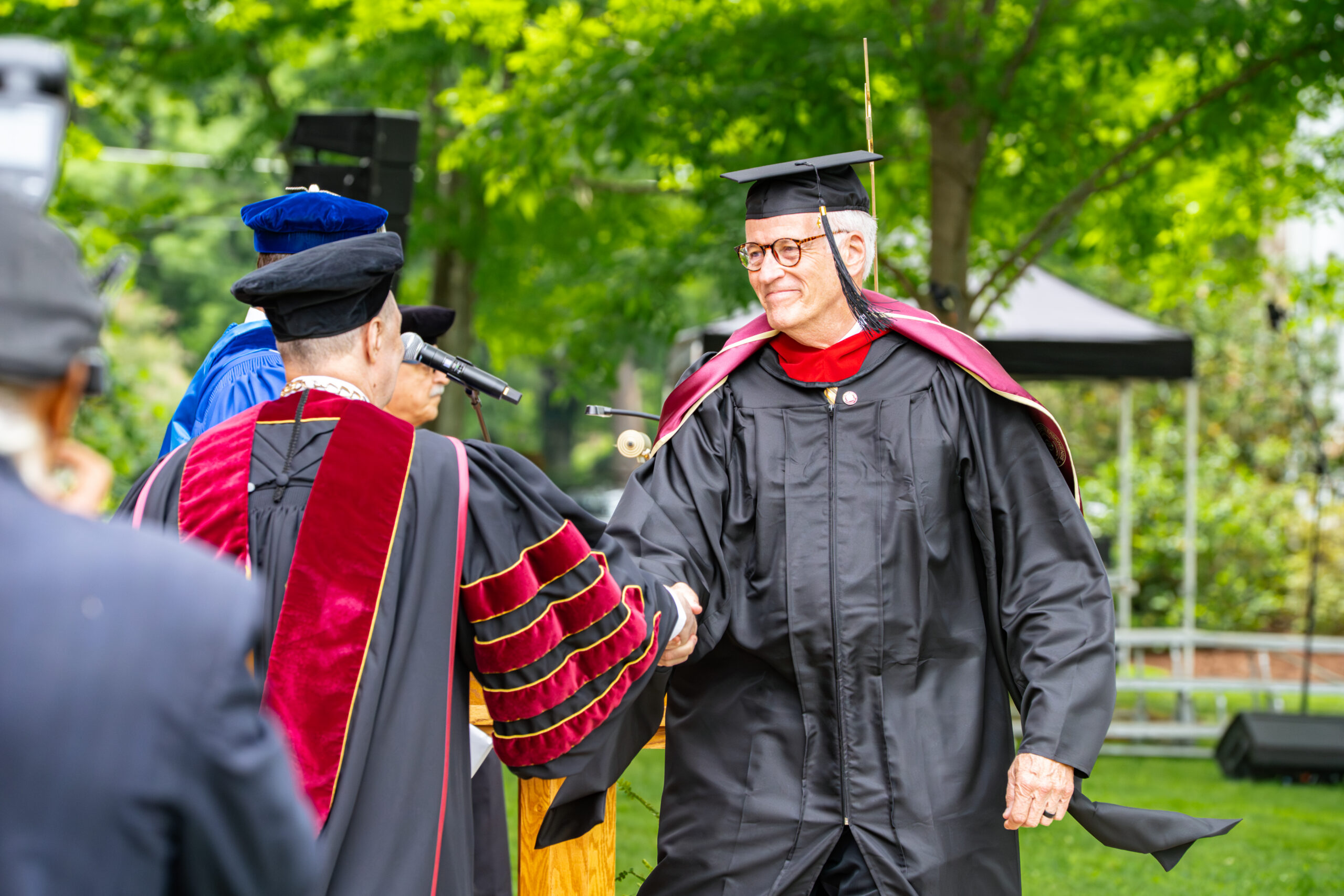 MACC graduate shakes hands with the Erskine College president