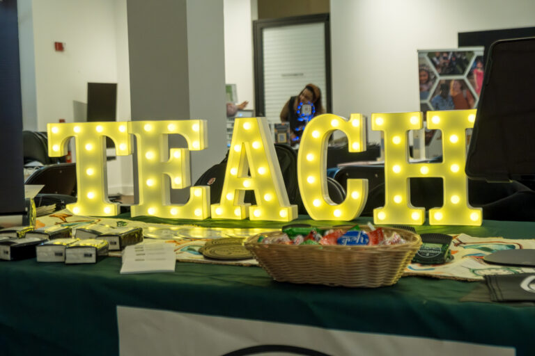 Light up sign that says "Teach"