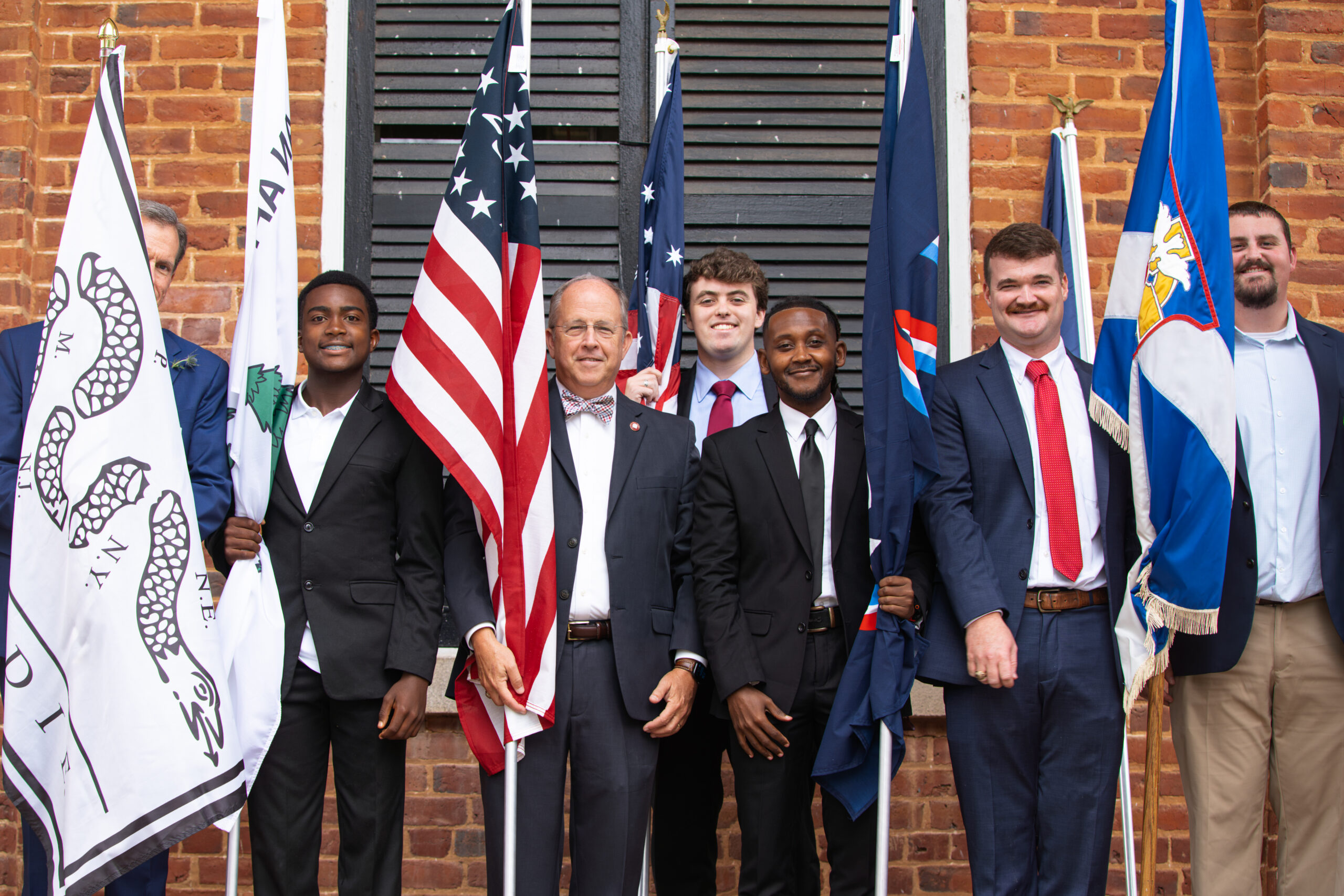 Alumni and friends carry flags for the 250 event